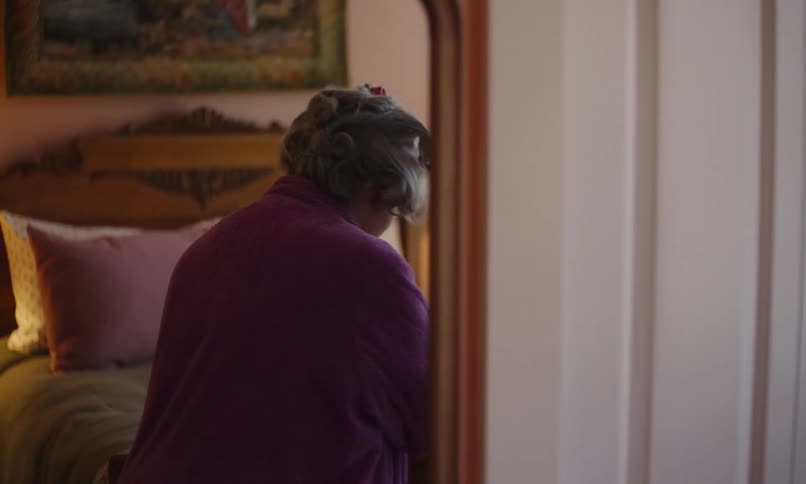 A woman removes rollers from her hair