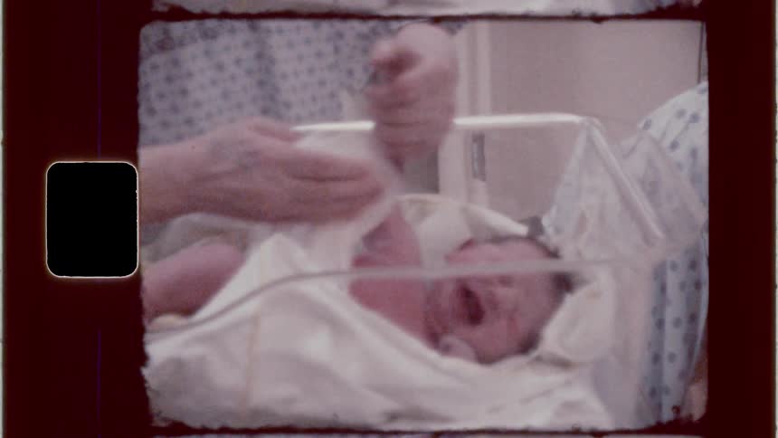 New mother gives a sponge bath to her newborn in the hospital
