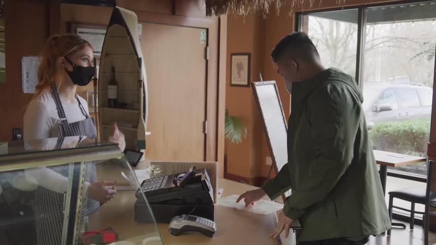 A man goes to the counter and orders