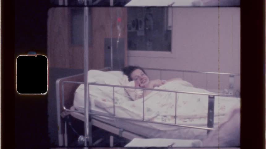 Happy new mom holding newborn after giving birth at the hospital