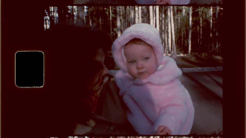 A mother is holding her baby