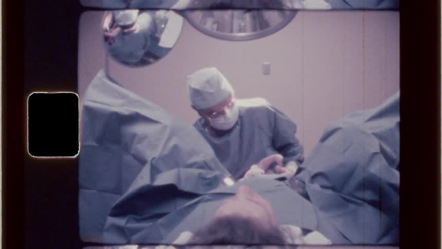 The doctor delivers the baby and holds it up for the parents to see