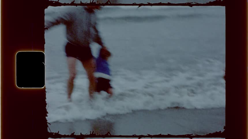 A child and adult running through the water on a beach