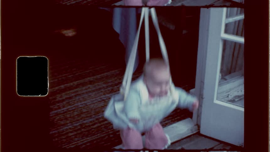 A baby is jumping up and down on the porch