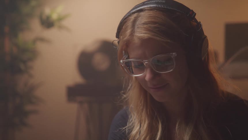 A woman is listening to music on her headphones