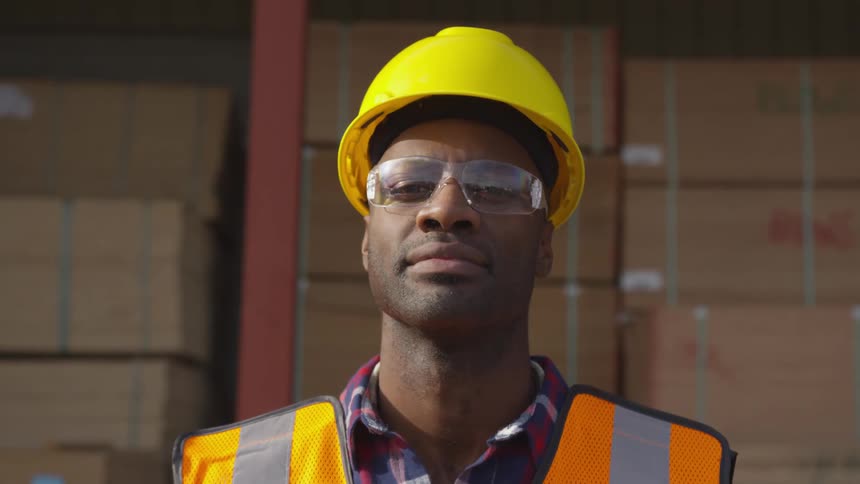 Boy in work uniform turning his gaze toward the camera