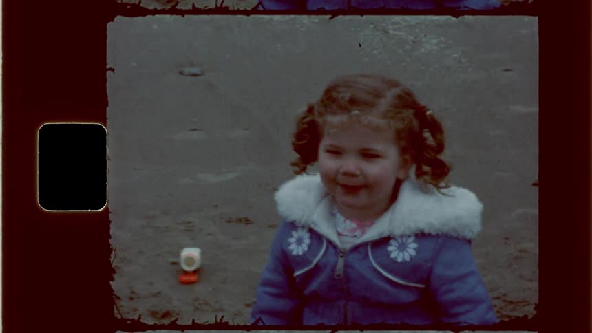 Little girl above the beach playing