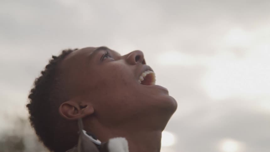 Man yelling at the clouds under a gray sky