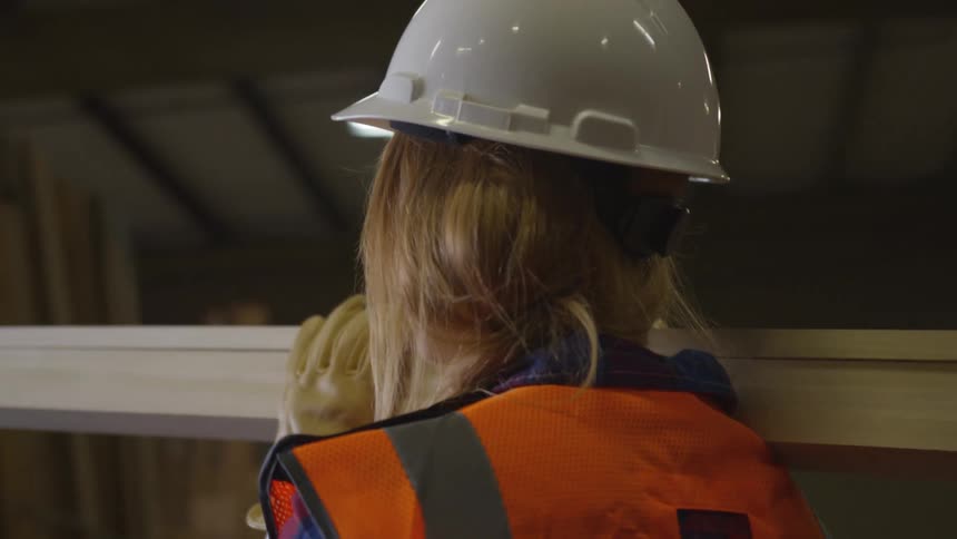 A footage of a lady lifting a wood
