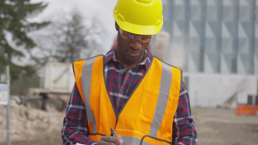 A construction worker is at the job site during the daytime