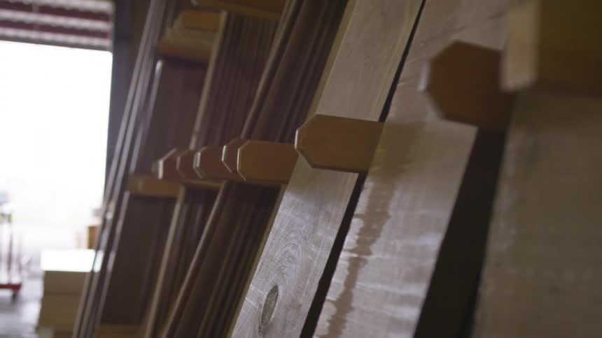 Lumber lined up between dividers in an open warehouse