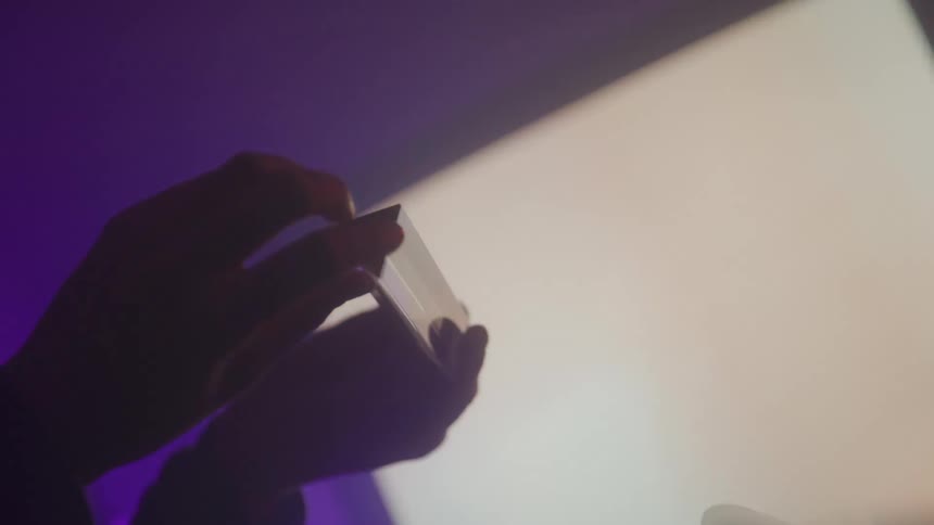 A clip of a person holding a silver crystal