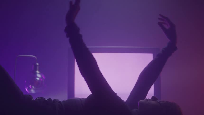 A footage of a lady waving her hands in the room