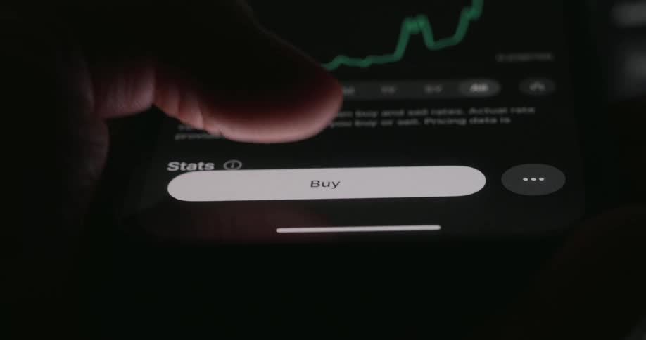 Person taps their smartphone to purchase a stock