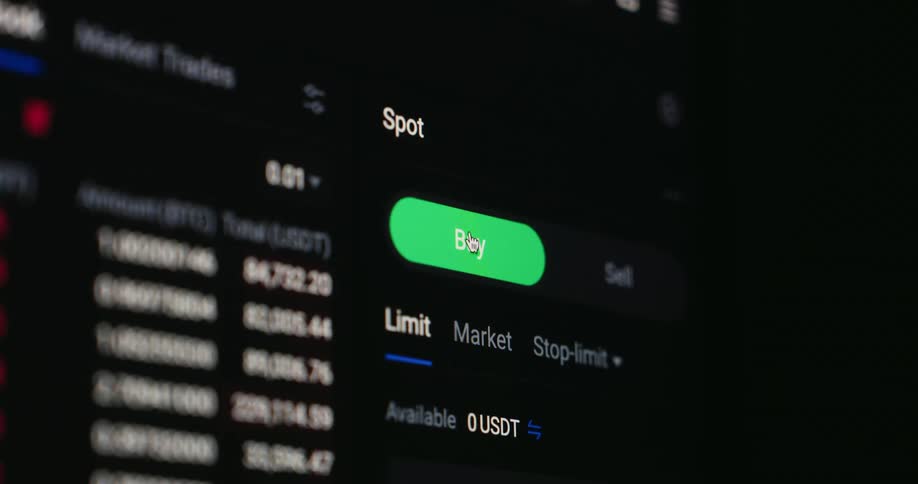 A mouse cursor clicks the green buy button on a cryptocurrency trading app highlighting the digital interface and live price data