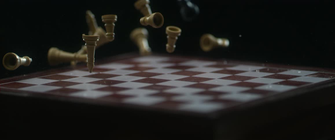 Chess pieces fall on a chess board