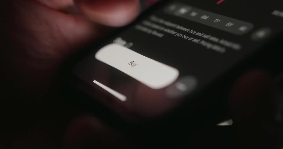 Finger pressing the buy button on a cell phone