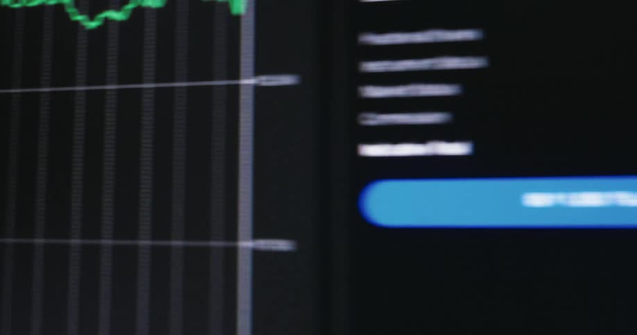 A cryptocurrency graph is on the monitor
