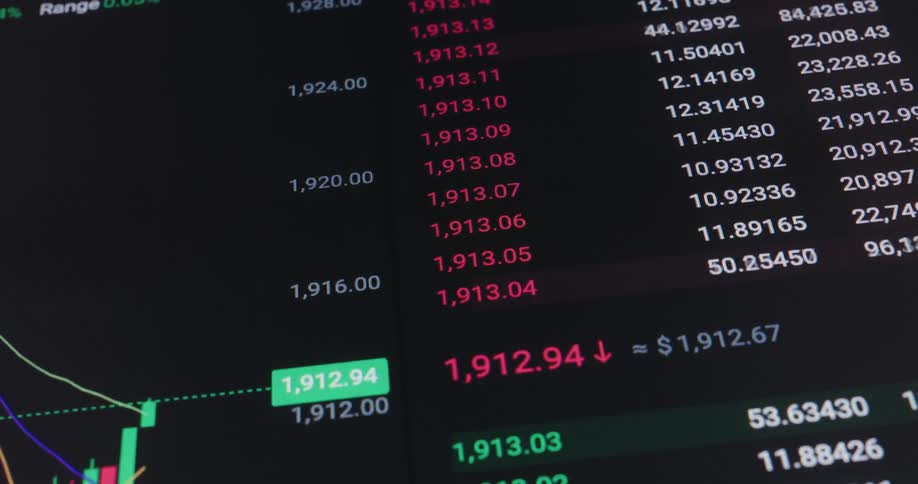 Numbers scrolling next to a chart showing fluctuations in stocks