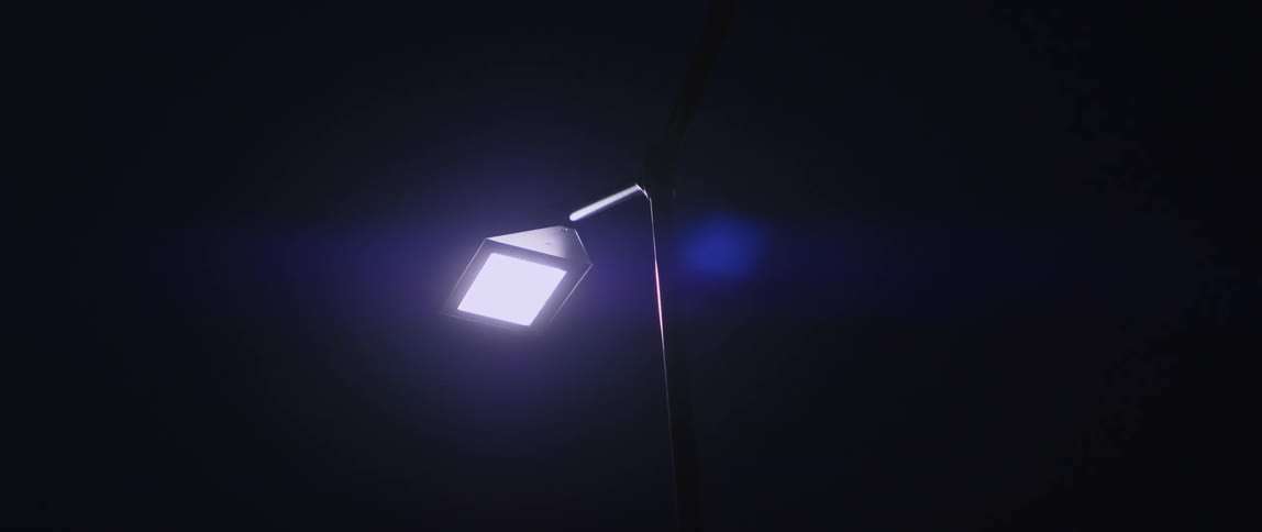A lamp post is the only light in this black sky
