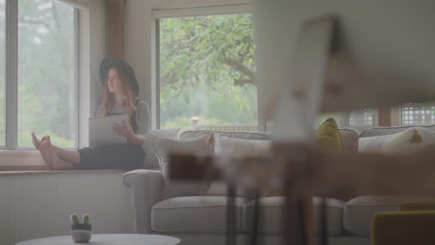 A woman is drawing on a pad