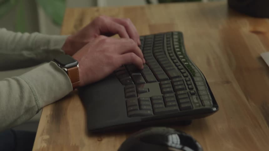 Boy writing using a keyboard and mouse
