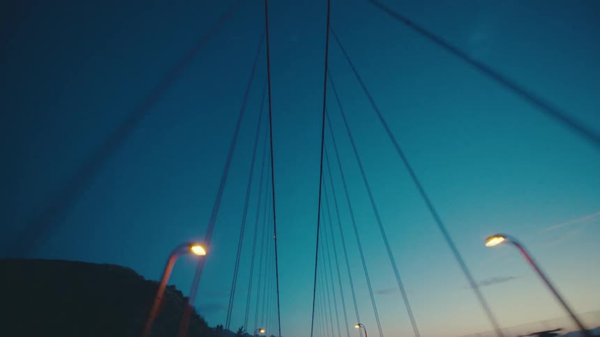 The sun is rising on the cable bridge