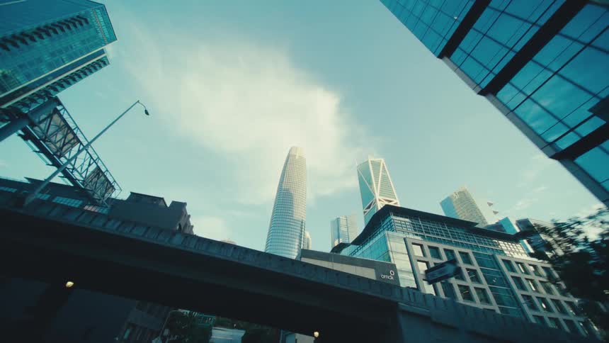 Skyscrapers tower above a downtown metropolis on a partly sunny summer day