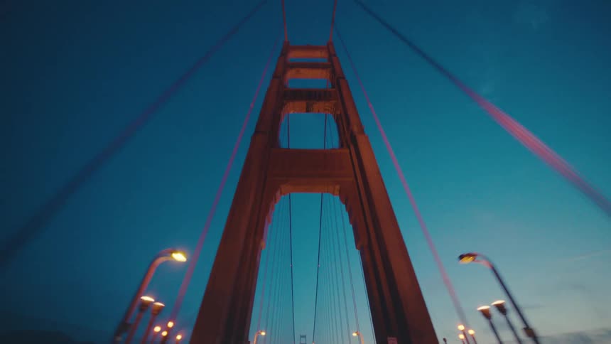 Moving backwards on a suspension bridge at dusk