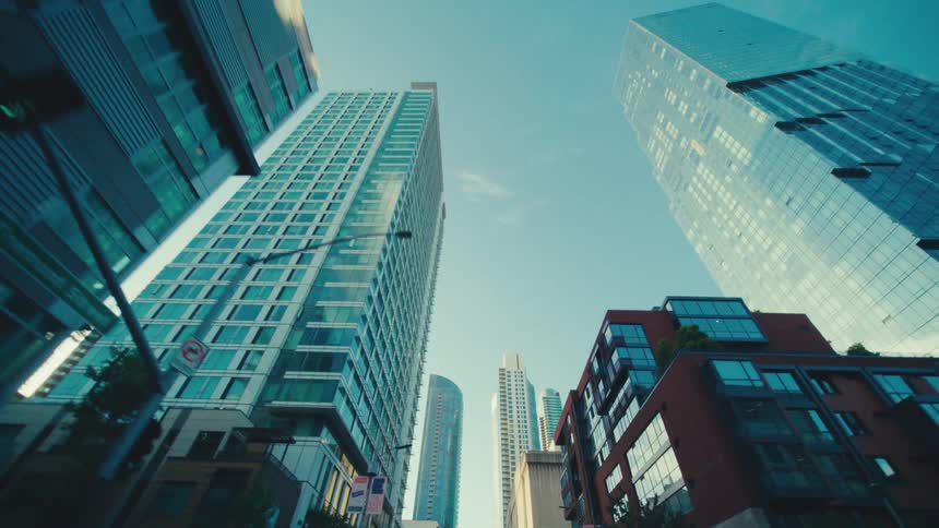 The tall buildings reflect the sun in the city