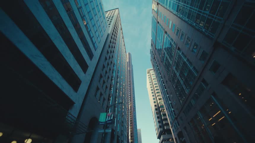 Towering skyscrapers of a cityscape under a blue sky