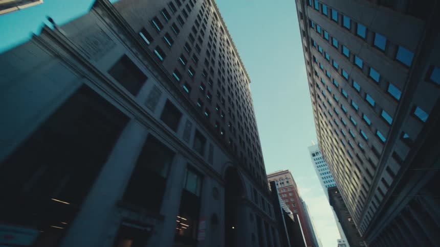 The tall building creates shade on the city