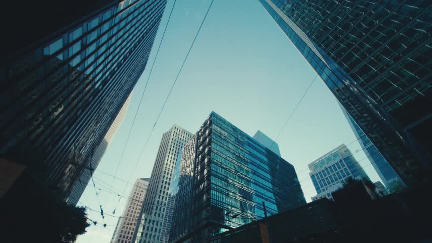 Cables running across the street between tall buildings in the city