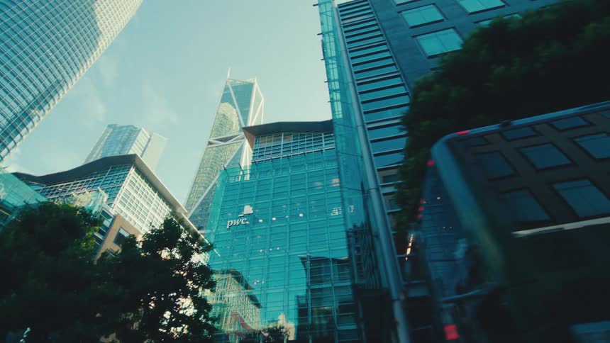 Multiple downtown skyscrapers reflect nearby buildings