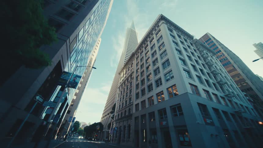 Skyscrapers tower over many shorter buildings in the city surrounding mostly empty streets