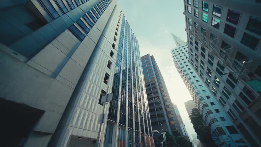Sunlight reflects on the windows of the tall buildings