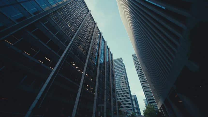 The tall buildings cast shade on the road