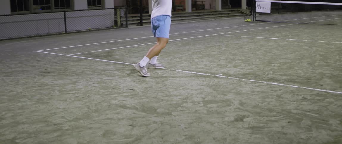 Man returning a tennis ball with his racket that was hit towards him