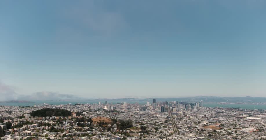 The city below has a clear sky above