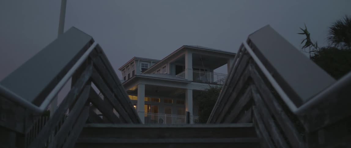 The wooden stairs lead up to the home at dawn