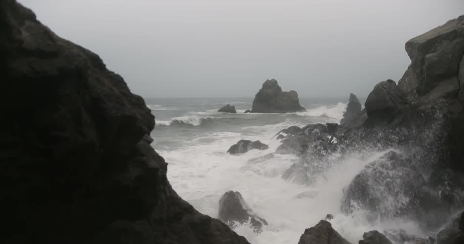 Waves crash into the rocky shoreline