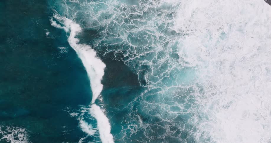 Large foamy waves reach toward an unseen shore