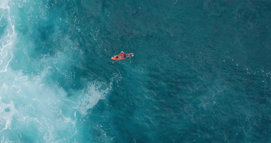 Person paddling on a paddleboard in the ocean