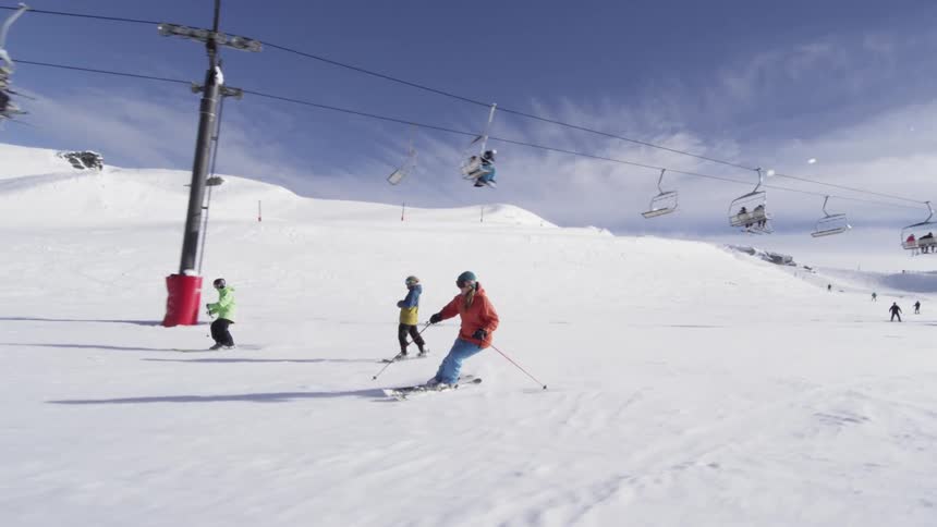 Skiers descend a snowy mountain