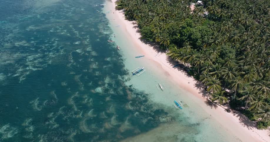Boats are docked on the sand of the beach