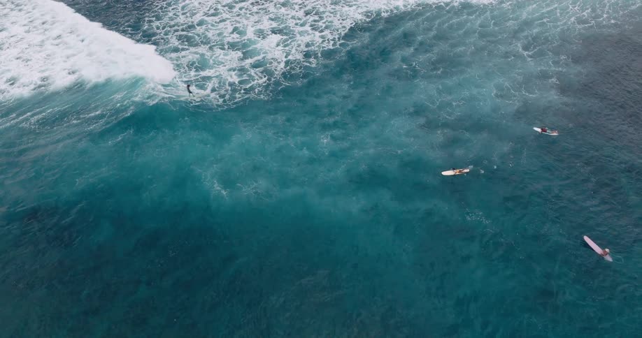 People are surfing on the blue waves