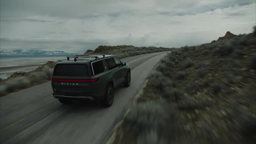 The vehicle travels on the small mountain road on a cloudy day
