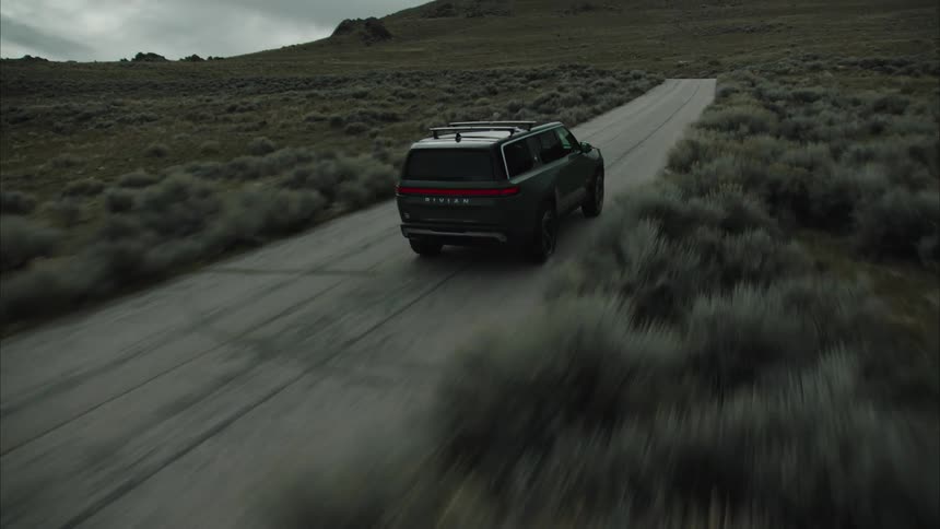 A person driving a car in a rural landscape in spring