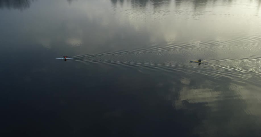 Two kayaks move through the water