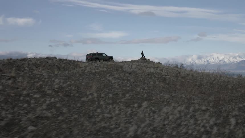 A footage of a person standing beside a truck